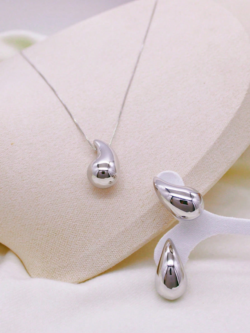 Acessórios: Colar e brincos com formato de gotas.